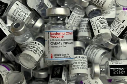 (FILES) This file photo taken on April 20, 2021 shows an empty vial of the Moderna Covid-19 vaccine among empty vials of different other vaccines by Pfizer-BioNTech (Comirnaty) and AstraZeneca at the vaccination center in Rosenheim, southern Germany, amid the novel coronavirus / COVID-19 pandemic. - German health authorities on November 10, 2021 advised against the use of the Moderna coronavirus vaccine for people under 30 due to evidence of a small risk of cardiac inflammation. The Stiko vaccine commission cited studies showing that mRNA jabs led in rare cases to the conditions myocarditis (inflammation of the heart muscle) and pericarditis (inflammation of the tissue surrounding the heart) in younger patients, with slightly higher prevalence in those who received Moderna. (Photo by Christof STACHE / AFP)<!-- NICAID(14940297) -->