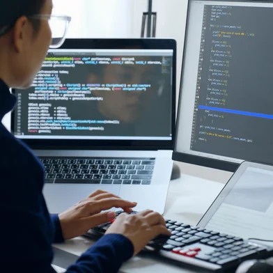 Young Asian woman, developer programmer, software engineer, IT support, wearing glasses working on computer to check coding in bugging system. Back viewFonte: 500709335<!-- NICAID(15185742) -->