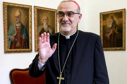 Cardinal Pierbattista Pizzaballa, Latin Patriarch of Jerusalem, gestures during an interview at the patriarchate headquarters in the old city of Jerusalem on April 22, 2025. Cardinals from all over the world will be in Rome for the funeral of Pope Francis, who died on April 21, 2025, and to take part in the General Congregations (preparatory meetings) before the conclave. Among them, 135 cardinal electors, those under the age of 80, will take part in the vote. Diplomats, practitioners, theologians and mediators: Pizzaballa is one of 15 whose votes will count when the time comes to cast their ballots. Although some of them are regularly presented by observers as "papabili", i.e. favourites to succeed Francis, the outcome of the conclave is always unpredictable, making any prognosis very hazardous. (Photo by Menahem Kahana / AFP)<!-- NICAID(16021496) -->