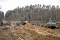 This handout made available by Lithuanian Ministry of National Defence shows a digger and a bulldozer at the site of rescue operation for missing US soldiers at Pabrade training ground, in Lithuania, on March 27, 2025. Lithuanian Defense Minister Dovile Sakaliene said that "all scenarios" were still being considered regarding the fate of four American soldiers who went missing during an exercise in the east of the country, stressing that their search continued under difficult conditions. (Photo by Lukas Kalvaitis / Lithuanian Ministry of National Defence / AFP) / RESTRICTED TO EDITORIAL USE - MANDATORY CREDIT "AFP PHOTO / Lithuanian Ministry of National Defence/Lukas Kalvaitis  " - NO MARKETING NO ADVERTISING CAMPAIGNS - DISTRIBUTED AS A SERVICE TO CLIENTS<!-- NICAID(16004540) -->