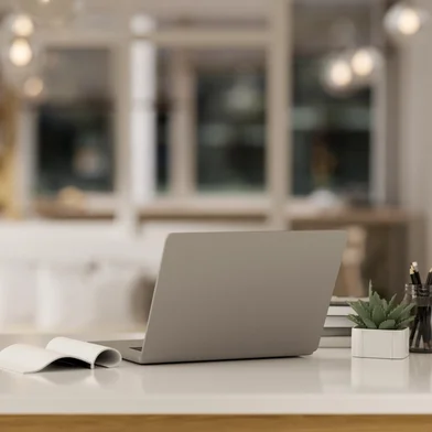 Workspace with a laptop computer and accessories on a white tabletop in a modern, luxury living roomWorkspace with a laptop computer and accessories on a white tabletop in a modern, luxury living room. close-up image. 3d render, 3d illustrationFonte: 691336741<!-- NICAID(15702537) -->