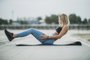 Young Fit Woman Doing Sit Ups During Working Up OutdoorsBeautiful fit woman doing sit ups while exercising outdoors, on riverside city promenade.Indexador: Milan MarkovicFonte: 456595921Fotógrafo: Young Fit Woman Doing Sit Ups Du<!-- NICAID(15478603) -->