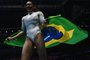 First-placed Brazil's Rebeca Andrade celebrates with the Brazilian flag after wining the Women's individual all-around final at the World Gymnastics Championships in Liverpool, northern England on November 3, 2022. (Photo by Ben Stansall / AFP) / RESTRICTED TO EDITORIAL USE - PUBLICATION OF SEQUENCES IN EXCESS OF 5 IMAGES/SECOND IS PROHIBITED<!-- NICAID(15255101) -->
