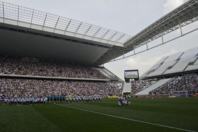 Football players line up before the Brazilian championship football match between Corinthians and Figueirense as part of the official inauguration of the Arena de Sao Paulo stadium, on May 18, 2014, in Sao Paulo, Brazil. The Arena de Sao Paulo, of Brazilian team Corinthians, will host the opening match of the Brazil 2014 FIFA World Cup between Brazil and Croatia on June 12. AFP PHOTO / NELSON ALMEIDA<!-- NICAID(10502429) -->