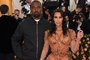 (FILES) In this file photo taken on May 06, 2019, Kim Kardashian and Kanye West arrive for the 2019 Met Gala at the Metropolitan Museum of Art on May 6, 2019 in New York. - Superstar Kim Kardashian West said Friday, May 10, 2019 that she and rapper Kanye West have welcomed their fourth child, a boy born via surrogate. Kardashian has been open about her struggles with pregnancy and decision to use a surrogate, as she had previously suffered from placenta accreta -- a serious condition where the placenta becomes too deeply attached to the wall of the uterus. (Photo by ANGELA WEISS / AFP)