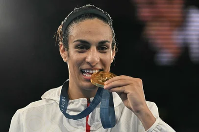 (FILES) Gold medallist Algeria's Imane Khelif poses on the podium during the medal ceremony for the women's 66kg final boxing category during the Paris 2024 Olympic Games at the Roland-Garros Stadium, in Paris on August 9, 2024. Algerian Olympic champion boxer Imane Khelif, who is at the centre of a row over gender eligibility, will not compete in this week's tournament in The Netherlands, organisers said on June 5, 2025. (Photo by MOHD RASFAN / AFP)<!-- NICAID(16053830) -->