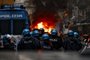 This photo obtained from Italian news agency Ansa shows Eintracht Frankfurt fans (Rear) clash with anti-riot police on March 15, 2023 in downtown Naples prior to the UEFA Champions League round of 16, second leg football match between SSC Napoli and Eintracht Frankfurt to be played at the Diego-Maradona stadium in Naples. - Eintracht Frankfurt fans clashed with police on March 15 after arriving in Naples despite not having tickets for their team's Champions League decider with Napoli. (Photo by Ciro FUSCO / ANSA / AFP) / Italy OUT <!-- NICAID(15376232) -->