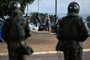 Supporters of Brazil's far-right ex-president Jair Bolsonaro leave the area while soldiers dismantle the camp they had set up in front of the Army headquarters in Brasilia, on January 9, 2023, a day after backers of the ex-president invaded the Congress, presidential palace and Supreme Court. - Brazilian security forces locked down the area around Congress, the presidential palace and the Supreme Court Monday, a day after supporters of ex-president Jair Bolsonaro stormed the seat of power in riots that triggered an international outcry. Hardline Bolsonaro supporters have been protesting outside army bases calling for a military intervention to stop Lula from taking power since his election win. (Photo by Mauro PIMENTEL / AFP)Editoria: WARLocal: BrasíliaIndexador: MAURO PIMENTELSecao: demonstrationFonte: AFPFotógrafo: STF<!-- NICAID(15315814) -->