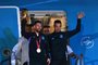 Argentina's captain and forward Lionel Messi (L) holds the FIFA World Cup Trophy alongside Argentina's coach Lionel Scaloni as they step off a plane upon arrival at Ezeiza International Airport after winning the Qatar 2022 World Cup tournament in Ezeiza, Buenos Aires province, Argentina on December 20, 2022. (Photo by Luis ROBAYO / AFP)<!-- NICAID(15299908) -->
