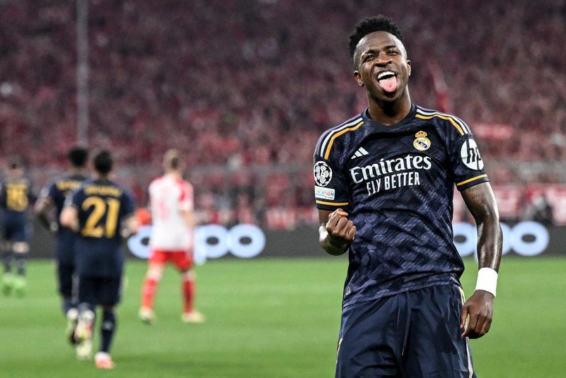 Real Madrid's Brazilian forward #07 Vinicius Junior celebrates scoring a penalty during the UEFA Champions League semi-final first leg football match between FC Bayern Munich and Real Madrid CF on April 30, 2024 in Munich, southern Germany. (Photo by Kirill KUDRYAVTSEV / AFP)<!-- NICAID(15750078) -->
