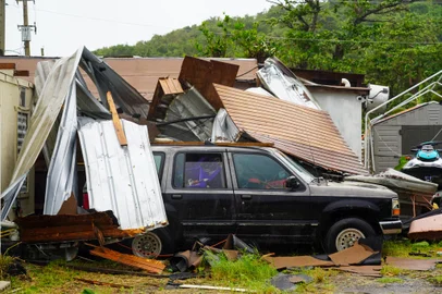 A view of vehicle damaged after Tropical Storm Ernesto hit Fajardo, Puerto Rico, on August 14, 2024. On August 13, Ernesto advanced through the Caribbean toward Puerto Rico, where officials shut down schools and sent workers home as forecasters warned of a possible hurricane.The storm was moving west toward the US island with maximum sustained winds of 50 miles per hour (85kph), according to the National Hurricane Center. (Photo by Jaydee Lee SERRANO / AFP)Editoria: WEALocal: FajardoIndexador: JAYDEE LEE SERRANOSecao: warningFonte: AFPFotógrafo: STR<!-- NICAID(15840778) -->