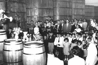 Solenidade do jubileu de prata da Cooperativa Vinícola Aliança, fundada em 4 de janeiro de 1931, em Caxias do Sul. Em meio aos barris da adega, foi improvisado um altar para o padre Pedro Rizzon celebrar a missa alusiva ao jubileu de prata, em janeiro de 1956.<!-- NICAID(15655459) -->
