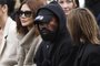 (FILES) In this file photo taken on October 02, 2022 US rapper Kanye West (C), attends the Givenchy Spring-Summer 2023 fashion show during the Paris Womenswear Fashion Week, in Paris. - Social network Parler announced October 17, 2022 a deal for Kanye West to buy the platform popular with US conservatives, just over a week after the rapper's Twitter and Instagram accounts were restricted over anti-Semitic posts. (Photo by JULIEN DE ROSA / AFP)Editoria: ACELocal: ParisIndexador: JULIEN DE ROSASecao: mass mediaFonte: AFPFotógrafo: STR<!-- NICAID(15244905) -->