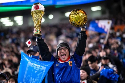 A Japanese fan cheers before the 2026 FIFA World Cup Asian qualification football match between Japan and Bahrain in Saitama on March 20, 2025. (Photo by Philip FONG / AFP)<!-- NICAID(15999478) -->