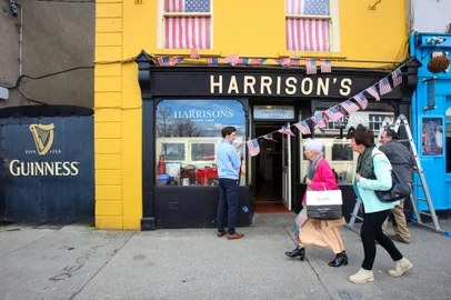 'Stars and Stripes' bunting is hung outside a bar in Ballina town centre on April 7, 2023 as the town prepares to welcome President Biden to the town in Co Mayo, the his ancestral home. - The picturesque town of Ballina on the banks of the river Moy in northwest Ireland hums with activity ahead of a visit by its most famous son Joe Biden this week. The US president is due to arrive in Ballina in north County Mayo on Friday to address thousands in the town from which his family hailed before emigrating to Pennsylvania in the 19th century. (Photo by Paul Faith / AFP)<!-- NICAID(15398611) -->