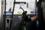 A worker holds a gasoline hose at a gas station in Buenos Aires, on October 30, 2023. Long lines of cars to load fuel and gas stations with "sold out" signs have been part of the landscape for several days in Argentina, while the government pressures oil companies to speed up supply and agricultural producers warned of protests three weeks before the presidential runoff. The shortage is due to scheduled stops at two refineries, a peak in seasonal consumption and greater demand from the field, said a joint statement from the main oil companies, which estimated a normalization of supply "in the coming days." (Photo by Luis ROBAYO / AFP)Editoria: FINLocal: Buenos AiresIndexador: LUIS ROBAYOSecao: energy and resourceFonte: AFPFotógrafo: STF<!-- NICAID(15583595) -->
