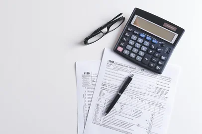 US Individual income tax return. US tax forms on desk. Wide image with copy space<!-- NICAID(16238795) -->