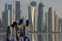 Workers are backdropped by the skyline of Doha as they walk along the Corniche seafront promenade in Doha early morning on November 17, 2022, ahead of the Qatar 2022 World Cup football tournament. (Photo by Mariana SUAREZ / AFP)Editoria: SPOLocal: DohaIndexador: MARIANA SUAREZSecao: soccerFonte: AFPFotógrafo: STF<!-- NICAID(15268037) -->