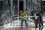 Supporters of Brazilian former President Jair Bolsonaro destroy a window of the the plenary of the Supreme Court in Brasilia on January 8, 2023. - Hundreds of supporters of Brazil's far-right ex-president Jair Bolsonaro broke through police barricades and stormed into Congress, the presidential palace and the Supreme Court Sunday, in a dramatic protest against President Luiz Inacio Lula da Silva's inauguration last week. (Photo by Ton MOLINA / AFP)<!-- NICAID(15316378) -->