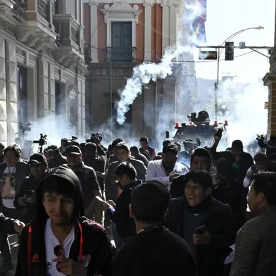 Military troops fire tear gas at people outside the Quemado Palace at the Plaza Murillo in La Paz on June 26, 2024. Bolivian President Luis Arce on Wednesday denounced the unauthorized gathering of soldiers and tanks outside government buildings in the capital La Paz, saying "democracy must be respected." "We denounce irregular mobilizations by some units of the Bolivian Army," Arce wrote on the X social network. Former president Evo Morales wrote on the same medium that "a coup d'état is brewing." (Photo by AIZAR RALDES / AFP)<!-- NICAID(15798875) -->