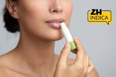 Lips nutrition. Girl applying hygienic balm over grey background, panorama<!-- NICAID(16284984) -->