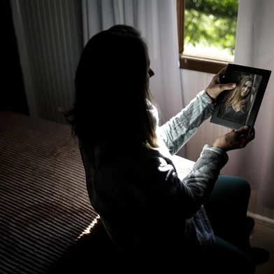 FELIZ, RS, BRASIL, 25-06-2025: A mãe, Marcia Elisa Müller, 61 anos, observa uma foto de Raíssa Müller, 21 anos, vítima de feminicídio na casa onde morava em Feliz, no Vale do Caí. Raíssa e o companheiro dela, Eric Richard de Oliveira Turato, 24, foram assassinados a facadas pelo ex-namorado dela em 18 de abril. O Rio Grande do Sul registrou 10 feminicídios no feriado de Páscoa, seis deles na Sexta-feira Santa. Agora, por pressão de deputadas gaúchas, o governo do RS deve recriar Secretaria da Mulher, extinta em 2015. Foto: Mateus Bruxel/Agência RBSIndexador: MATEUS BRUXEL<!-- NICAID(16067891) -->