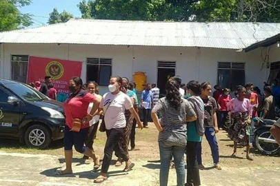 Villagers stand outside a building in Maumere in East Nusa Tenggara on Flores island on December 14, 2021, after a 7.3-magnitude earthquake struck off the coast in eastern Indonesia. (Photo by YANUARIUS ARLINO WELIANTO / AFP)<!-- NICAID(14967609) -->