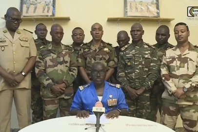 This video frame grab image obtained by AFP from ORTN - Télé Sahel on July 26, 2023 shows Colonel Major Amadou Abdramane (C), spokesperson for the National Committee for the Salvation of the People (CNSP) speaking during a televised statement. Soldiers claimed on July 26, 2023 to have overthrown the government of Niger President Mohamed Bazoum in a statement read out on national television, after a day in which the leader was detained in his official residence."We, the defence and security forces... have decided to put an end to the regime" of President Bazoum, said Colonel-Major Amadou Abdramane, surrounded by nine other uniformed soldiers in the address. They said "all institutions" in the country would be suspended, borders were closed, and a curfew had been imposed "until further notice". (Photo by ORTN - Télé Sahel / AFP)<!-- NICAID(15493374) -->