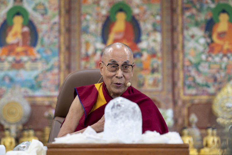 This handout photograph taken on April 22, 2022 and released by the Office of His Holiness the Dalai Lama (OHHDL) shows the Tibetan spiritual leader the Dalai Lama watching at a block of ice from the Khardung La glacier presented to him by India's climate activist Sonam Wangchuk (not pictured) on the occasion of the Earth Day in McLeod Ganj. (Photo by Office of His Holiness the Dalai Lama (OHHDL) / AFP) / -----EDITORS NOTE --- RESTRICTED TO EDITORIAL USE - MANDATORY CREDIT "AFP PHOTO/Office of His Holiness the Dalai Lama (OHHDL)" - NO MARKETING - NO ADVERTISING CAMPAIGNS - DISTRIBUTED AS A SERVICE TO CLIENTS<!-- NICAID(15076271) -->