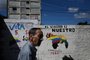 A man walks by a mural campaigning for a referendum to ask Venezuelans to consider annexing the Guyana-administered region of Essequibo, in 23 de Enero neighbourhood in Caracas on November 28, 2023. Venezuela is scheduled to hold a controversial referendum on December 3, to annex a disputed oil-rich territory administered by neighbouring Guyana. The government of Nicolas Maduro has organized the poll to ask Venezuelans to consider annexing the Essequibo region, which makes up two-thirds of tiny Guyana but is claimed by Caracas. (Photo by Federico PARRA / AFP)<!-- NICAID(15613868) -->