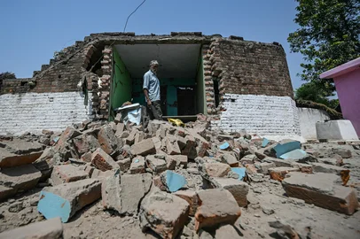 Bairi Ram, a local resident, stands next to his house damaged by overnight Pakistani artillery shelling in Kotmaira village near the Line of Control (LoC) in India's Jammu region on May 11, 2025. India and Pakistan traded accusations of ceasefire violations early on May 11, hours after US President Donald Trump announced that the nuclear-armed neighbours had stepped back from the brink of full-blown war. (Photo by Money SHARMA / AFP)<!-- NICAID(16034710) -->