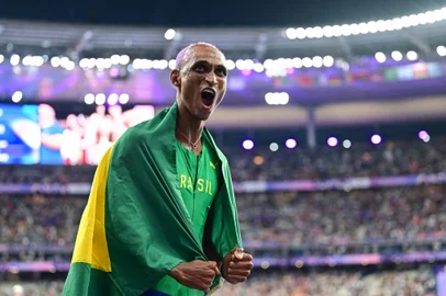 Third placed Brazil's Alison Dos Santos celebrates after the men's 400m hurdles final of the athletics event at the Paris 2024 Olympic Games at Stade de France in Saint-Denis, north of Paris, on August 9, 2024. (Photo by Martin  BERNETTI / AFP)<!-- NICAID(15837289) -->