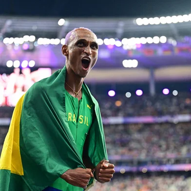 Third placed Brazil's Alison Dos Santos celebrates after the men's 400m hurdles final of the athletics event at the Paris 2024 Olympic Games at Stade de France in Saint-Denis, north of Paris, on August 9, 2024. (Photo by Martin  BERNETTI / AFP)<!-- NICAID(15837289) -->
