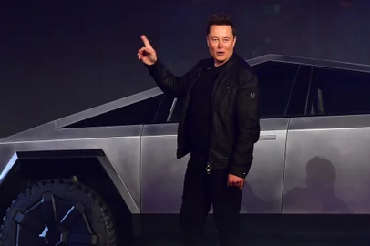 Tesla co-founder and CEO Elon Musk gestures while introducing the newly unveiled all-electric battery-powered Tesla Cybertruck at Tesla Design Center in Hawthorne, California on November 21, 2019. (Photo by Frederic J. BROWN / AFP)<!-- NICAID(14334669) -->