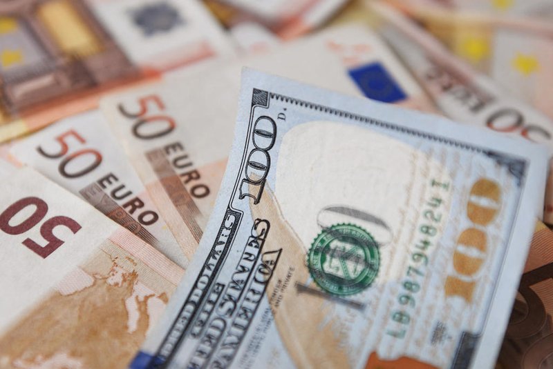 Uma nota de US $ 100 é vista em cima de notas de euro em Bogotá, em 12 de julho de 2022. - O euro atingiu a paridade com o dólar pela primeira vez em quase 20 anos na terça-feira, quando um corte no fornecimento de gás russo para a Europa aumentou os temores de uma recessão na zona euro. (Foto de DANIEL MUNOZ/AFP)<!-- NICAID(15147193) -->