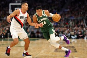 MILWAUKEE, WISCONSIN - NOVEMBER 26: Giannis Antetokounmpo #34 of the Milwaukee Bucks is defended by Malcolm Brogdon #11 of the Portland Trail Blazers during a game at Fiserv Forum on November 26, 2023 in Milwaukee, Wisconsin. NOTE TO USER: User expressly acknowledges and agrees that, by downloading and or using this photograph, User is consenting to the terms and conditions of the Getty Images License Agreement.   Stacy Revere/Getty Images/AFP (Photo by Stacy Revere / GETTY IMAGES NORTH AMERICA / Getty Images via AFP)<!-- NICAID(15609879) -->