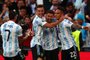 Argentina's striker Lautaro Martinez (R) celebrates with teammates after scoring the opening goal of the 'Finalissima' International friendly football match between Italy and Argentina at Wembley Stadium in London on June 1, 2022. - The Azzurri face the South American continental champions in the inaugural Finalissima at Wembley. (Photo by Adrian DENNIS / AFP)<!-- NICAID(15112488) -->