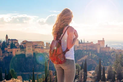 Woman tourist looking at Ancient arabic fortress Alhambra- Granada in SpainWoman tourist looking at Ancient arabic fortress Alhambra- Granada in SpainFonte: 562346432<!-- NICAID(16166978) -->