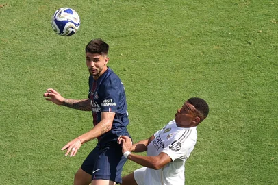 Paris Saint-Germain's Brazilian defender #04 Lucas Beraldo (L) fights for the ball with Real Madrid's French forward #09 Kylian Mbappe during the FIFA Club World Cup 2025 semifinal football match between France's Paris Saint-Germain and Spain's Real Madrid at MetLife stadium in East Rutherford, New Jersey on July 9, 2025. (Photo by CHARLY TRIBALLEAU / AFP)<!-- NICAID(16076955) -->