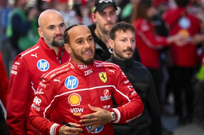 (FILES) British F1 driver Lewis Hamilton signs autographs during the Scuderia Ferrari HP Drivers' presentation event by Unicredit, in Piazza Castello in Milan, on March 6, 2025. The 2025 Formula One season marking 75 years since the inaugural seven-race championship in 1950, begins on March 14 with the Australian Grand Prix. (Photo by Piero CRUCIATTI / AFP)<!-- NICAID(15993152) -->