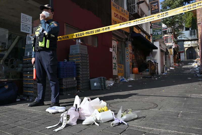 Flowers are laid at the scene of a Halloween stampede in the capital's popular Itaewon district in Seoul on October 30, 2022. - More than 150 people were killed and scores more injured in a stampede at a packed Halloween event in central Seoul late on October 29, officials said, in one of South Korea's worst peacetime accidents. (Photo by Jung Yeon-je / AFP)<!-- NICAID(15249717) -->