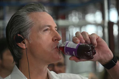 The Governor of California Gavin Newsom drinks acai juice during a visit to the dock area in the sidelines of the COP30 UN Climate Change Conference in Belem, Para State, Brazil, on November 11, 2025. President Donald Trump's administration may have steered clear of this year's UN climate summit in the Brazilian Amazon, but the conference's second day is nonetheless set to be dominated by the governors of California and New Mexico. (Photo by Mauro PIMENTEL / AFP)<!-- NICAID(16165044) -->