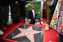 A portrait of US rapper Tupac Shakur is displayed next to his newly unveiled star during his Hollywood Walk of Fame star ceremony in Hollywood, California, on June 7, 2023. Slain rap legend Tupac Shakur was honored with a star on Hollywood's Walk of Fame on Wednesday, almost three decades after the best-selling artist was gunned down in a drive-by shooting. The ceremony paid tribute to a rapper who died at age 25 after a brief but spectacular career, in which he went from backup dancer to self-styled gangsta and one of the most influential figures in hip-hop. (Photo by Robyn Beck / AFP)<!-- NICAID(15451892) -->
