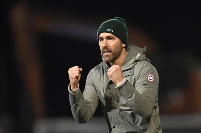 US actor and Wrexham owner Ryan Reynolds acknowledges the fans after the English FA Cup fourth round football match between Wrexham and Sheffield United at the Racecourse Ground Stadium in Wrexham, north Wales, on January 29, 2023. - The match ended in a draw at 3-3. (Photo by Oli SCARFF / AFP) / RESTRICTED TO EDITORIAL USE. No use with unauthorized audio, video, data, fixture lists, club/league logos or 'live' services. Online in-match use limited to 120 images. An additional 40 images may be used in extra time. No video emulation. Social media in-match use limited to 120 images. An additional 40 images may be used in extra time. No use in betting publications, games or single club/league/player publications. / <!-- NICAID(15343851) -->