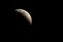 HUNTINGTON BEACH, CALIFORNIA - MAY 15: A total lunar eclipse creates a "super blood moon" on May 15, 2022 in Huntington Beach, California. The eclipse coincided with a super moon which occurs when the moon is at its closest point to earth.   Michael Heiman/Getty Images/AFP (Photo by Michael HEIMAN / GETTY IMAGES NORTH AMERICA / Getty Images via AFP)<!-- NICAID(15096922) -->