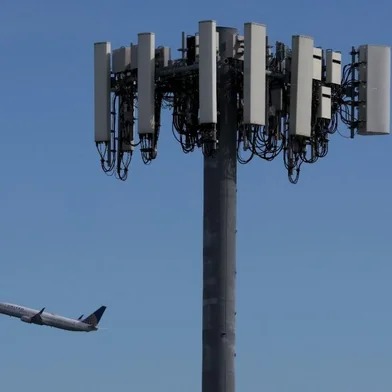 SAN FRANCISCO, CALIFORNIA - JANUARY 18: A United Airlines plane flies by a cellular tower as it takes off from San Francisco International Airport on January 18, 2022 in San Francisco, California. Verizon and AT&T announced that they will proceed with plans to activate 5G cellular service across the nation on Wednesday with the exception of near airports and runways after the Federal Aviation Administration and major airlines warned that the signal could interfere with navigational systems on some planes and cause flight disruptions.   Justin Sullivan/Getty Images/AFP (Photo by JUSTIN SULLIVAN / GETTY IMAGES NORTH AMERICA / Getty Images via AFP)<!-- NICAID(14993406) -->