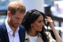 (FILES) In this file photo Britain's Prince Harry and wife Meghan arrive for a public walk at the Sydney Opera House in Sydney on October 16, 2018. - Britain's Prince Harry, who has blamed press intrusion for contributing to his mother Princess Diana's death in 1997, has told US chat show host Oprah Winfrey he was worried about history repeating itself. Harry and his wife Meghan Markle rocked Britain's monarchy with their shock announcement in January 2020 that they were stepping back from royal duties. CBS on February 28, 2021 released brief clips of an "intimate" interview with Winfrey about their lives which will air March 7. (Photo by DAN HIMBRECHTS / POOL / AFP)<!-- NICAID(14736939) -->