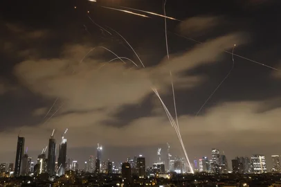 Israeli air defence systems intercept Iranian missiles over the Israeli city of Tel Aviv early on June 15, 2025. Air raid sirens and booms rang out in Jerusalem and Tel Aviv early on June 15, AFP journalists said, as Israel and Iran exchanged fire for a third day. (Photo by Jalaa MAREY / AFP)Editoria: WARLocal: Tel AvivIndexador: JALAA MAREYSecao: armed conflictFonte: AFPFotógrafo: STR<!-- NICAID(16059954) -->