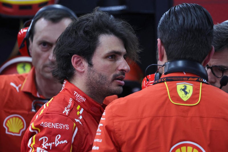 Ferrari's Spanish driver Carlos Sainz Jr talks to team members in the garage after the first practice session of the Saudi Arabian Formula One Grand Prix at the Jeddah Corniche Circuit in Jeddah on March 7, 2024. (Photo by Giuseppe CACACE / AFP)<!-- NICAID(15700175) -->