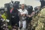 This handout picture released by the Ecuadorian Police shows former Ecuadorian vice president Jorge Glas being escorted by members of the Special Penitentiary Action Group (GEAP) during his arrival at the maximum security prison La Roca in Guayaquil on April 6, 2024. Ecuadorian authorities stormed the Mexican embassy in Quito on April 5 to arrest former vice president Jorge Glas, who had been granted political asylum there, prompting Mexico to sever diplomatic ties after the "violation of international law". (Photo by Handout / Ecuadorian Police / AFP) / RESTRICTED TO EDITORIAL USE - MANDATORY CREDIT "AFP PHOTO / ECUADORIAN POLICE" - NO MARKETING NO ADVERTISING CAMPAIGNS - DISTRIBUTED AS A SERVICE TO CLIENTS<!-- NICAID(15728294) -->